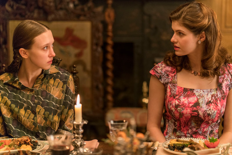 We Have Always Lived In The Castle Still - Merricat (Taissa Farmiga) and Contstance (Alexadra Daddario) Looking At One Another Dinner