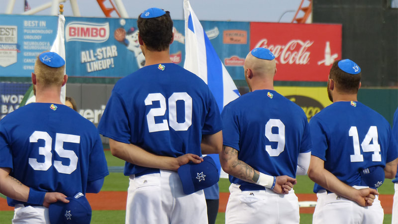 heading home: the tale of team israel still, team on baseball field in uniform, national anthem, israel flag