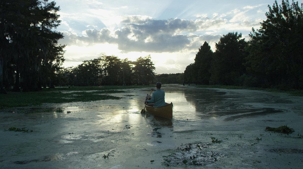 Behold The Earth Documentary Still: Canoe On River