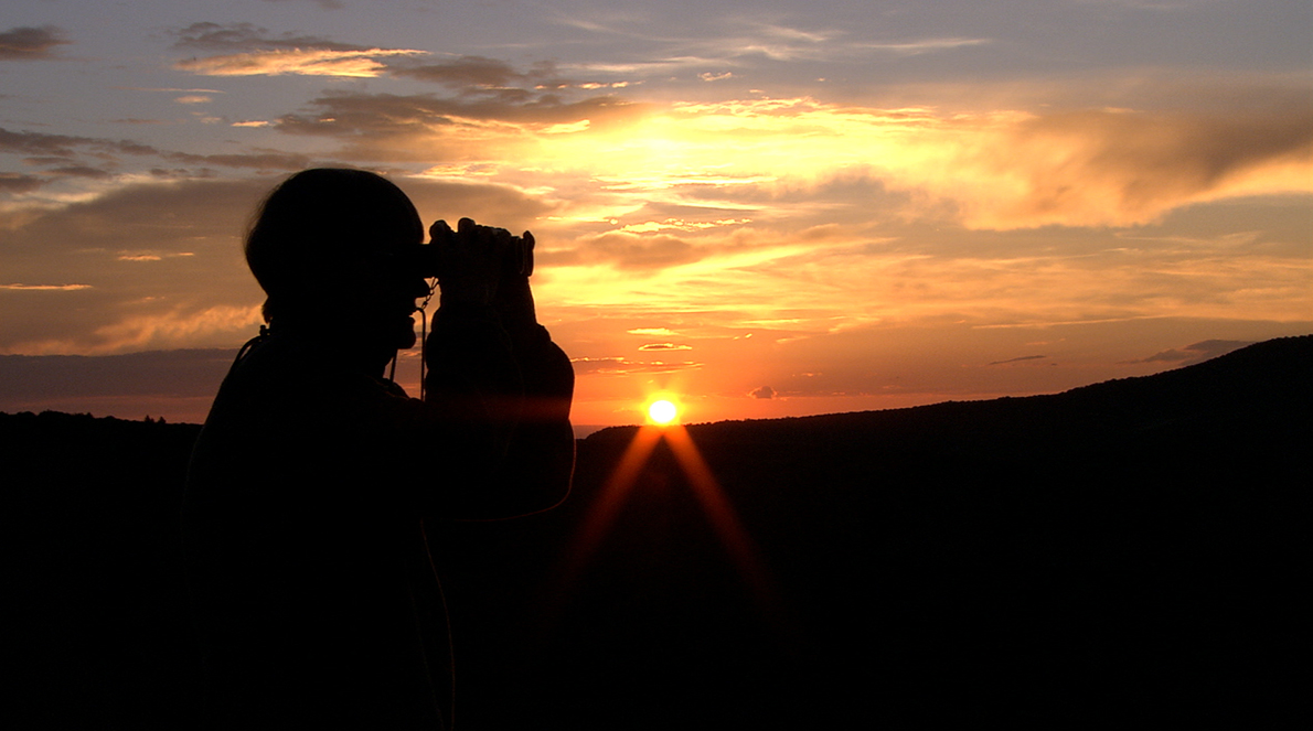 Behold The Earth Documentary Still: Man Looking Through Binoculars